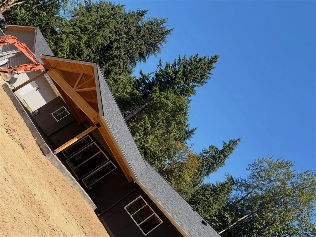 Cedar gable entry porch dark siding asphalt shingle roof