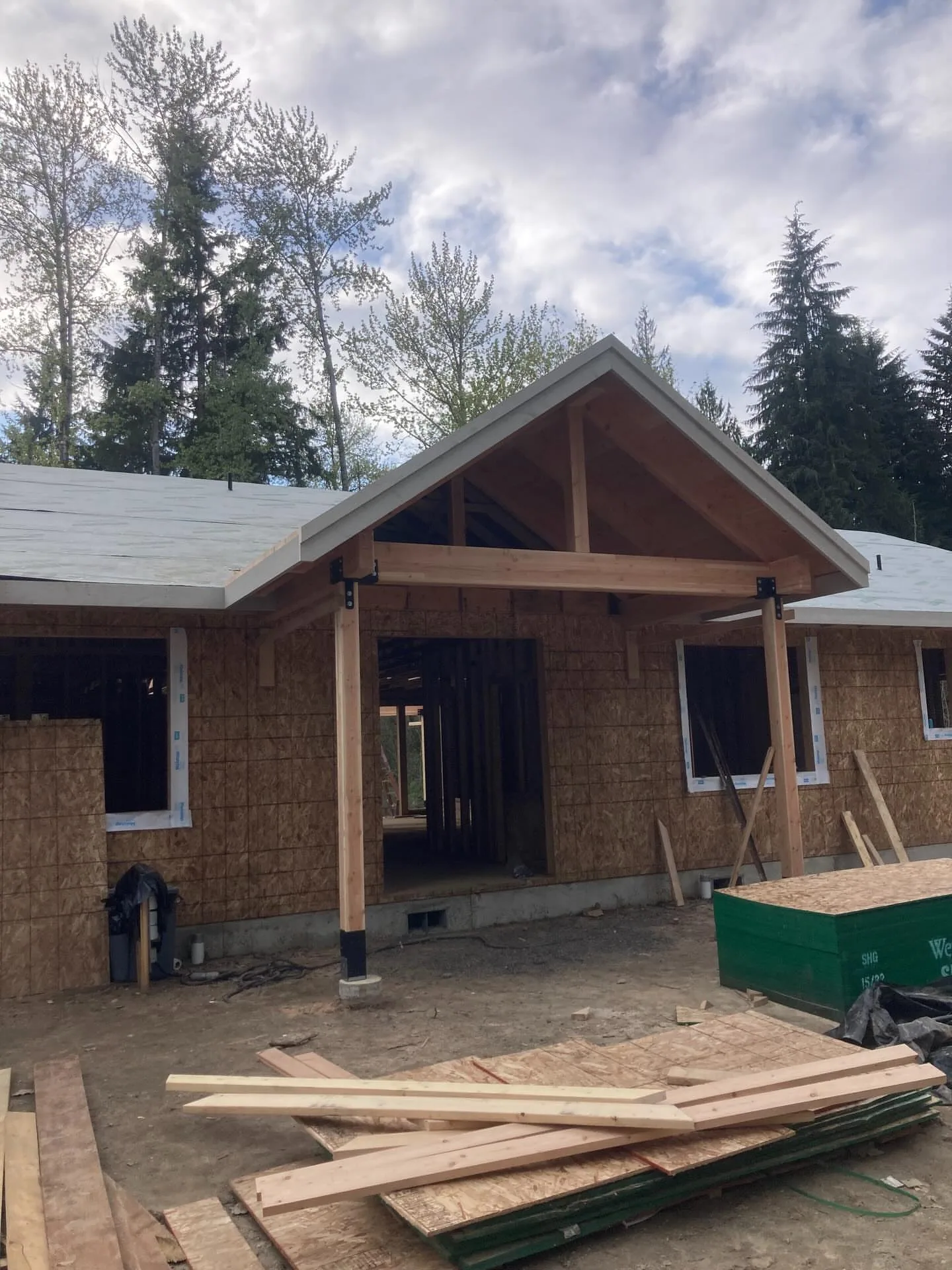 Front entry gable porch cedar posts osb walls