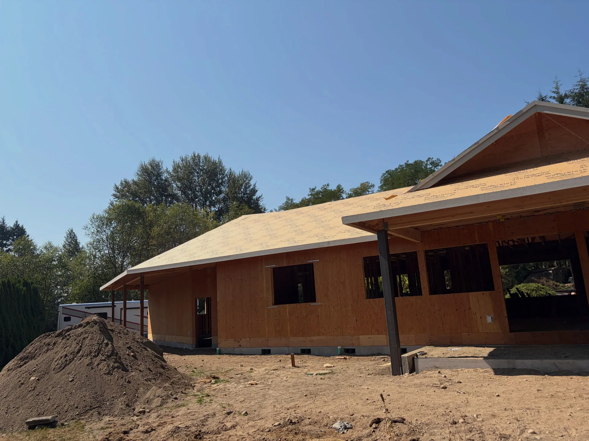 Plywood sheathed single story home dirt pile