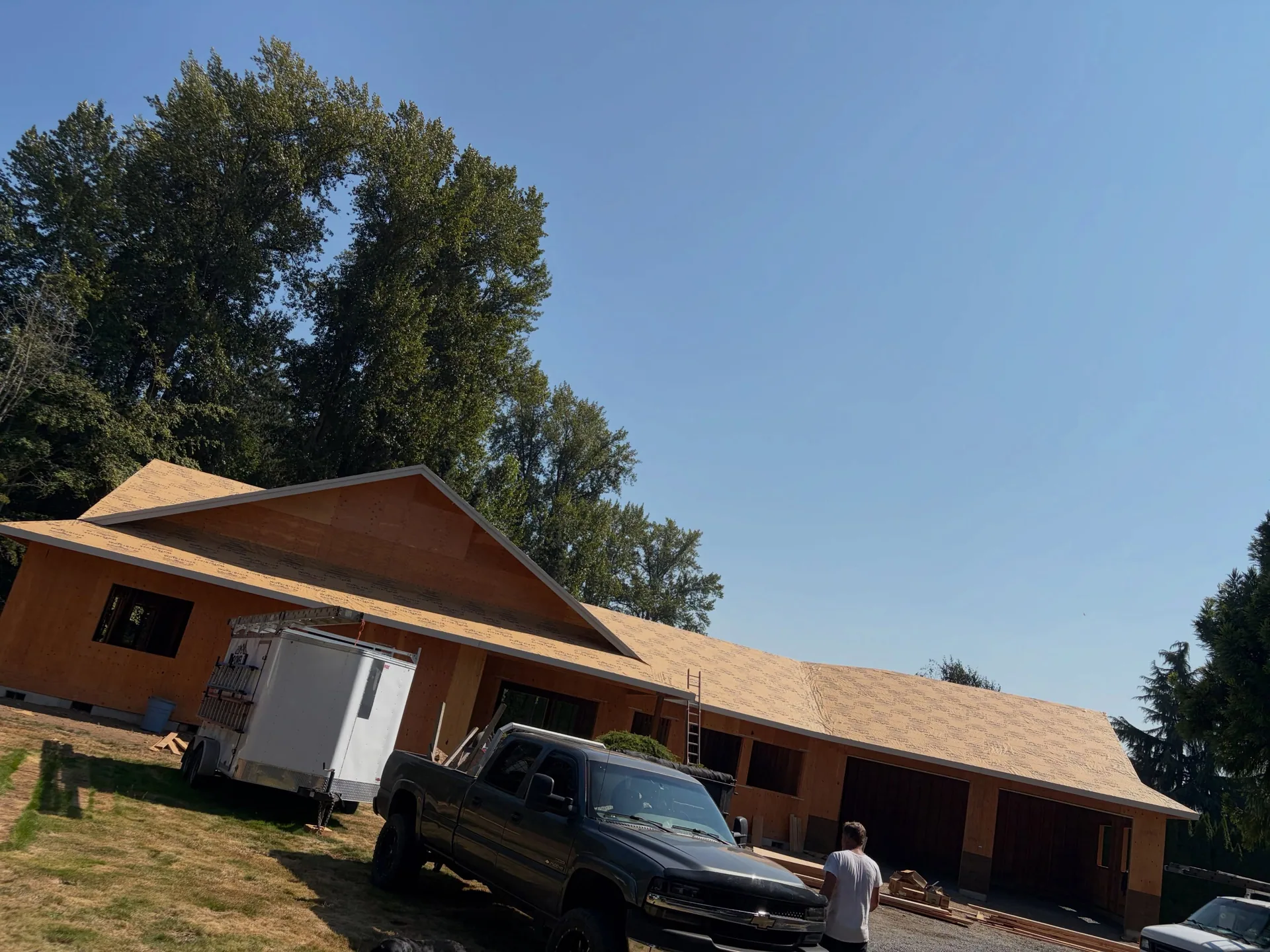 Roof sheathing attached garage pickup trailer job site
