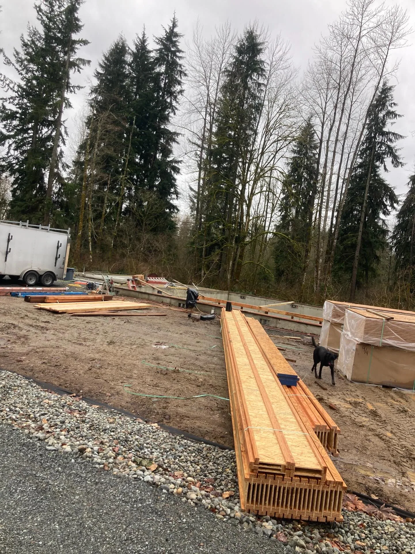 Stacked i joists wrapped lumber concrete foundation job site