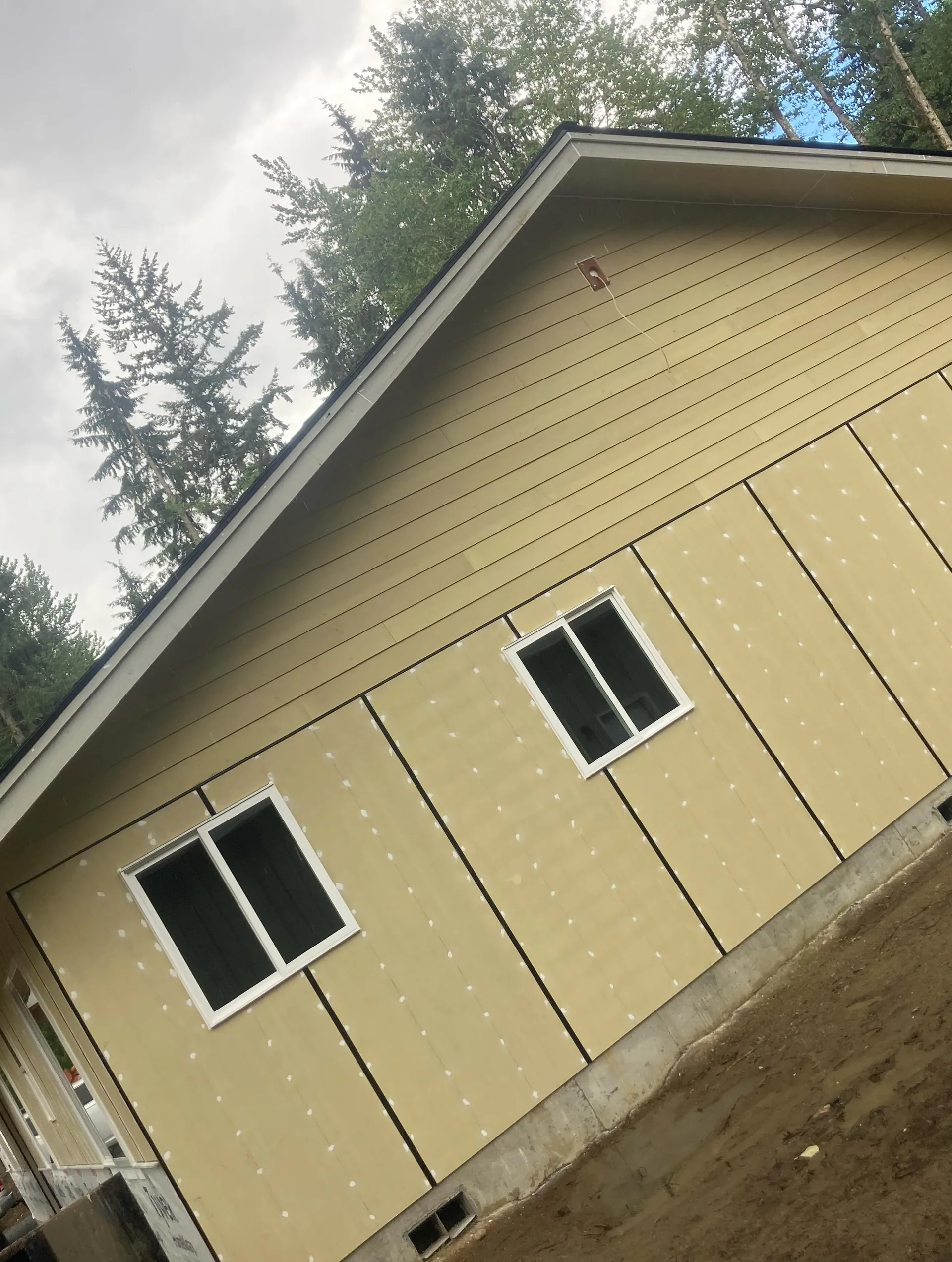 Tan lap siding install white vinyl windows gable end