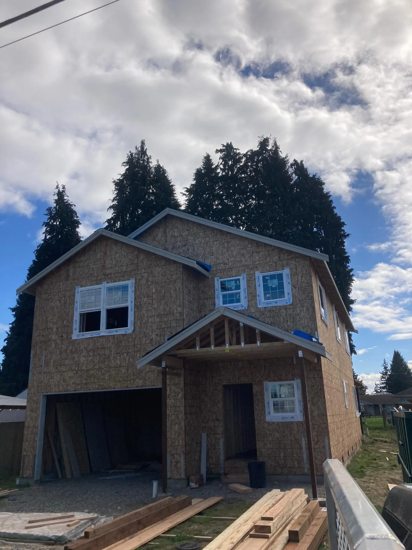 Two story osb sheathed home garage entry porch framing