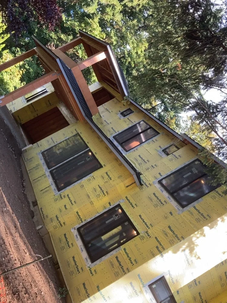 Yellow weathersmart wrap black framed windows timber porch